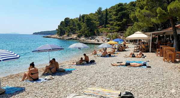 Kasjuni Beach Guide: The Most Instagrammable Spot in Split (2026) 3 Pebble beach at Kasjuni Split with tourists sunbathing