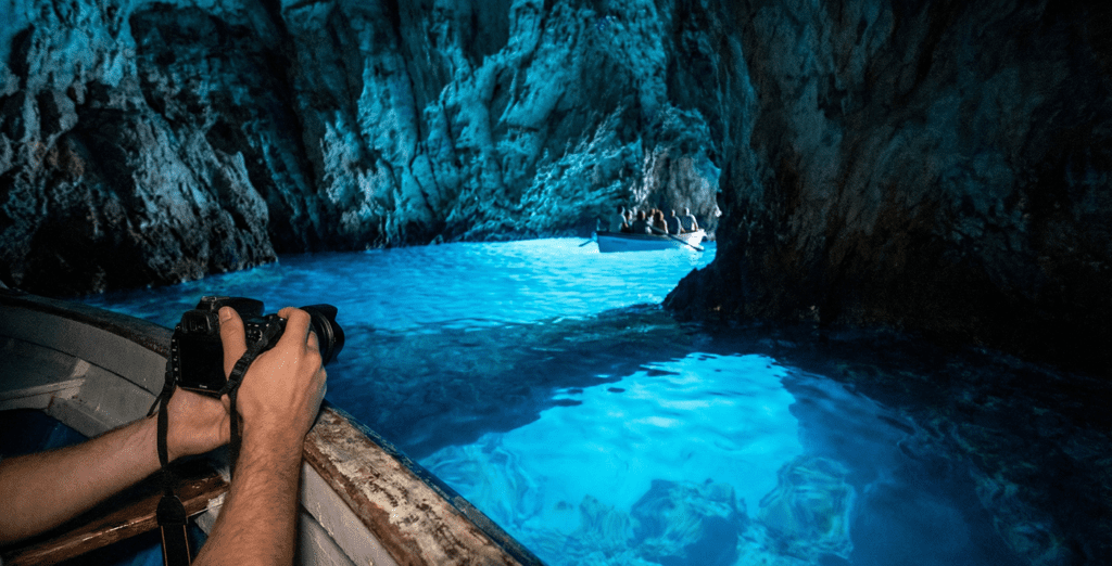 The Ultimate Blue Cave Tour Guide: Is It Worth the Hype in 2026? 2 Speedboat anchored in the turquoise Blue Lagoon Budikovac near Vis island