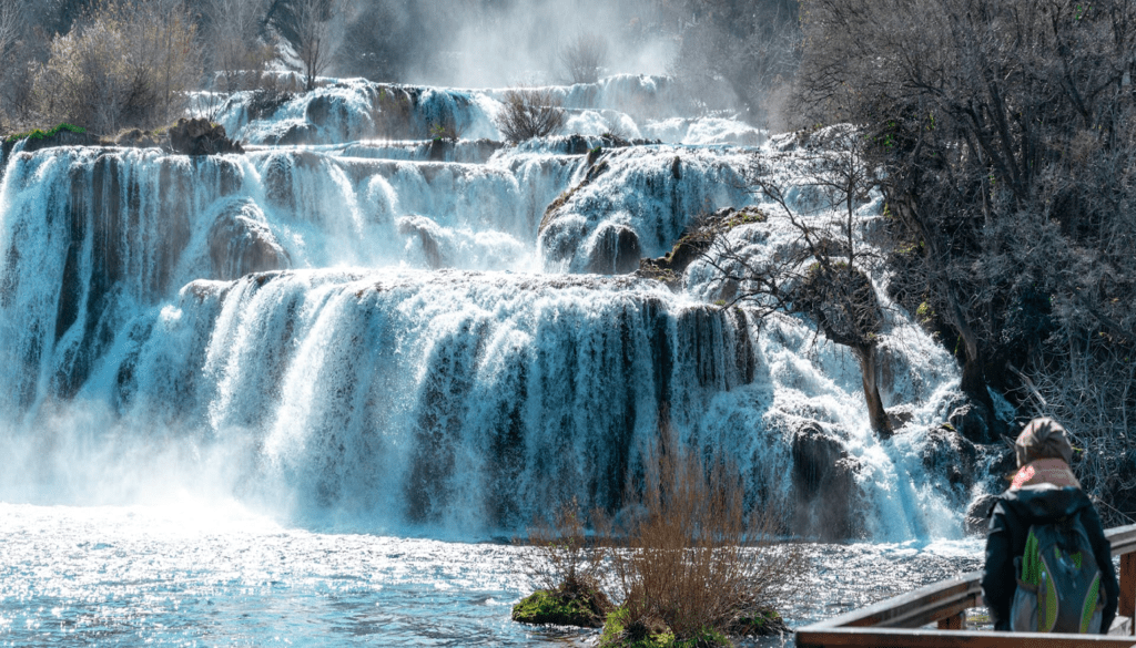 Krka National Park vs. Plitvice Lakes: The Honest Comparison for 2026 4 Scenic boat ride from Skradin through the river canyon towards Krka National Park waterfalls